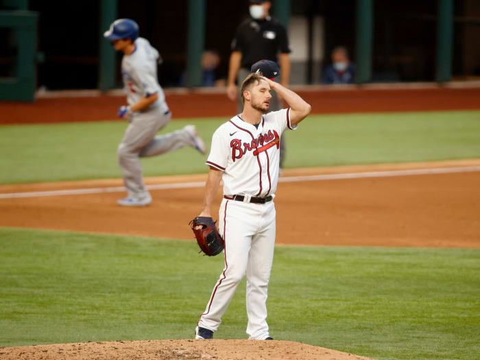 Oct 14, 2020; Arlington, Texas, USA; Atlanta Braves relief pitcher Grant Dayton (75) reacts after giving up a home run to Los Angeles Dodgers shortstop Corey Seager (background) during the third inning of game three of the 2020 NLCS at Globe Life Field.